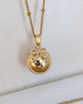 Bola de grossesse doré avec pendentif nœud