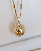 Bola de grossesse doré avec pendentif nœud
