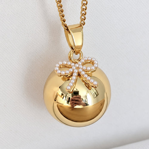 Bola de grossesse doré avec pendentif nœud