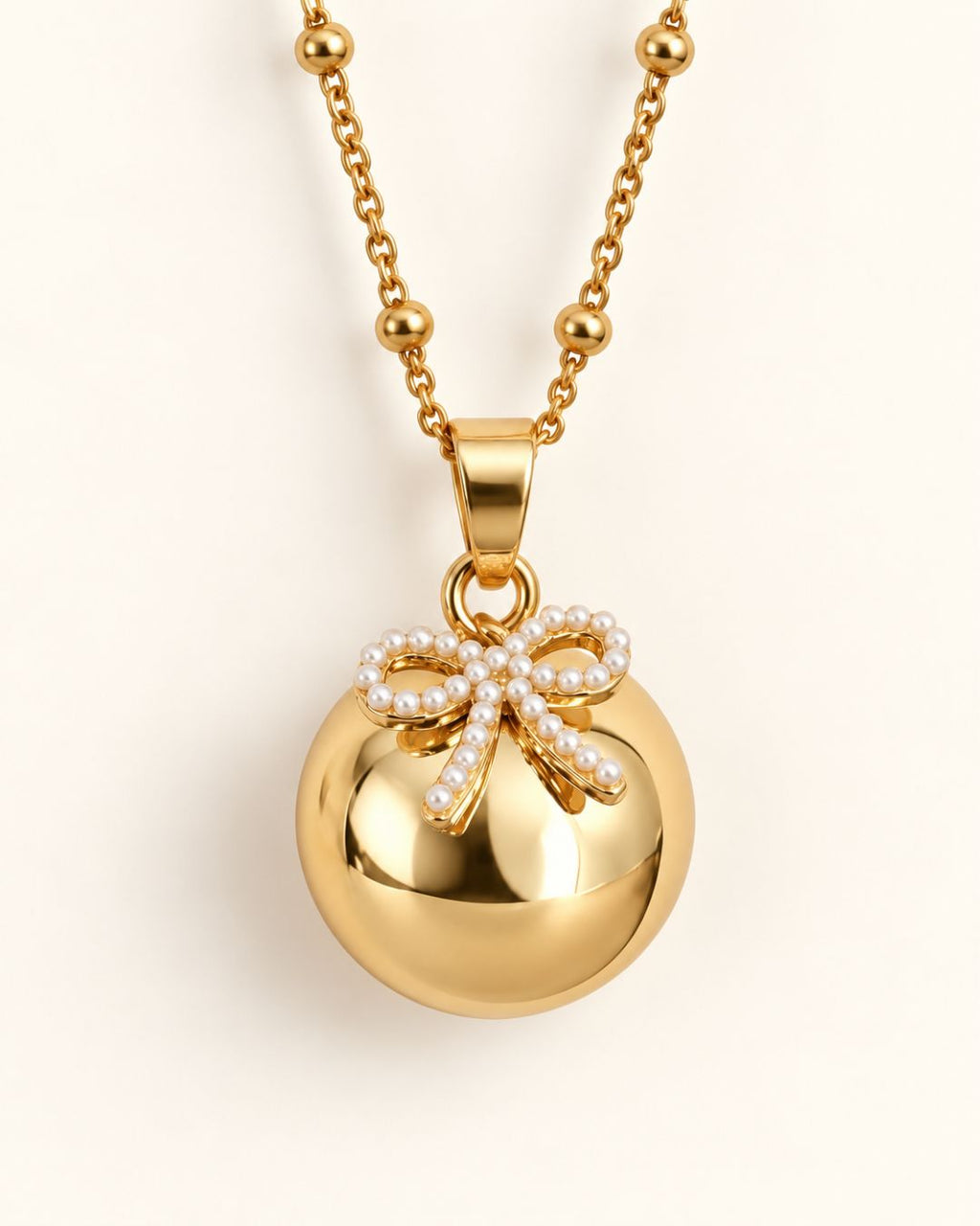Bola de grossesse doré avec pendentif nœud