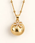 Bola de grossesse doré avec pendentif nœud