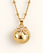 Bola de grossesse doré avec pendentif nœud
