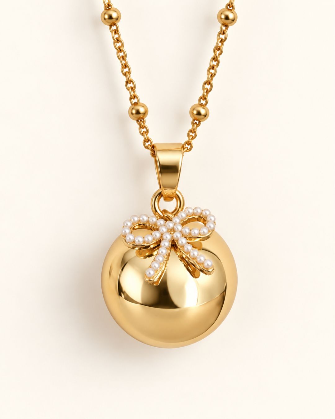 Bola de grossesse doré avec pendentif nœud
